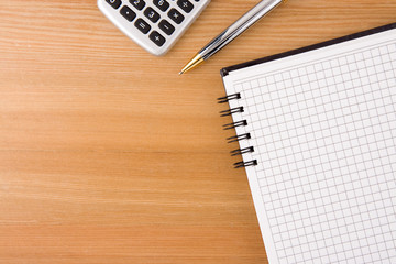 gold pen on checked notebook