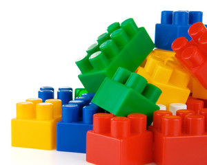 colorful plastic toys and bricks isolated on white