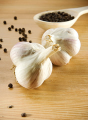 garlic and pepper on wooden spoon