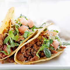 Beef tacos with lettuce cheese and tomato