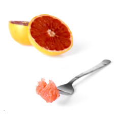 a fork with a piece of grapefruit