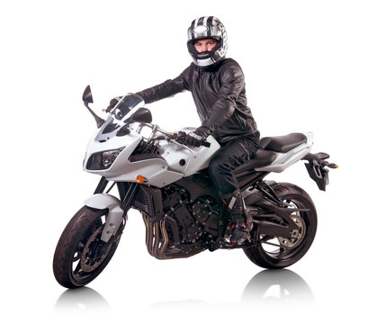 Fototapeta Biker in black leather jacket rides a white motorcycle