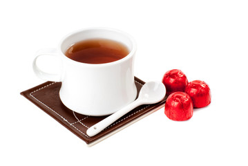 A cup of tea with sweets.