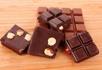 Many chocolate   pieces on brown background