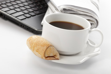 Cup of fragrant coffee on a morning paper business news