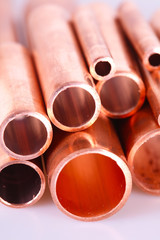 Set of copper pipes of different diameter lying in one heap