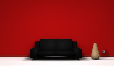 Schwarze Ledercouch vor roter Wand
