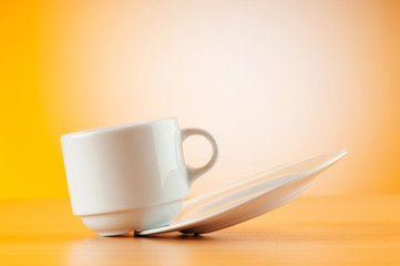 White cup against colourful gradient on the table