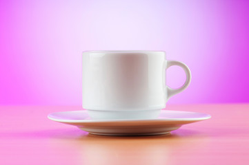 White cup against colourful gradient on the table