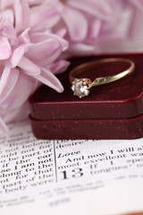 Engagement ring on the Bible open to 1st Corinthians 13