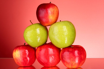Apples on red background