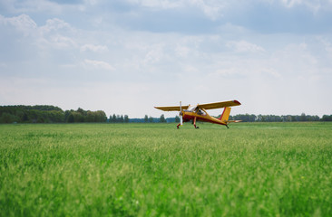 Little yellow airplane on field