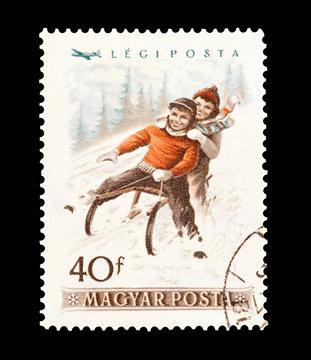 mail stamp printed in Hungary featuring winter sledging