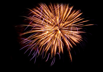 Fototapeta premium Fireworks Against the Night Sky Isolated on Black