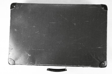 Obraz premium Vintage suitcase in black and white on white background