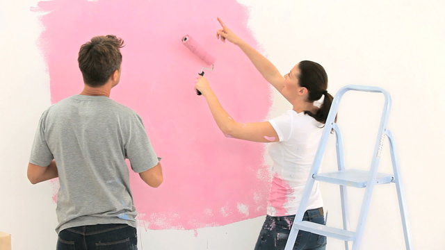 Nice couple painting the wall together