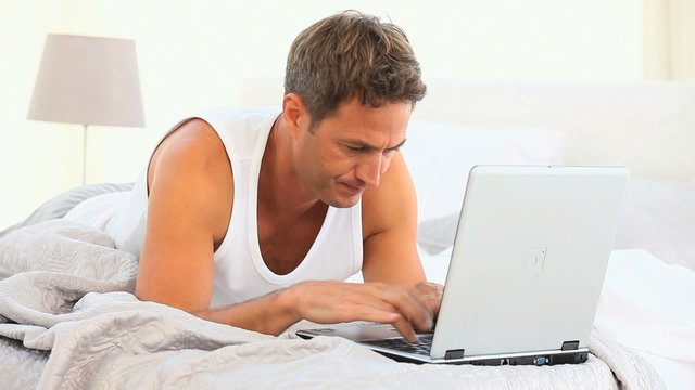 Anxious handsome man working on his laptop
