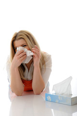 Beautiful young girl having a flu with paper tissues
