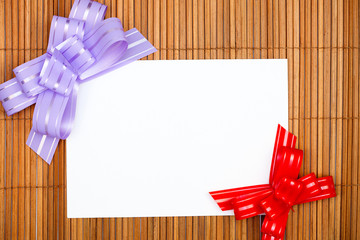Violet and red bows with paper card
