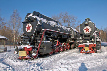 Steam locomotive beside a railway station platform.