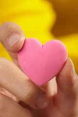 Fototapeta premium Woman holding pink heart in the hand