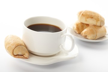 Cup of coffee with a roll