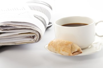 Cup of fragrant coffee on a morning paper business news