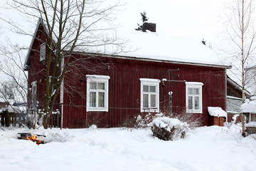 Rural house in winter covered with snow, North Europe