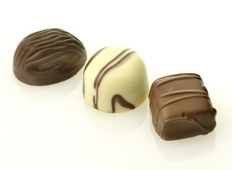 white and dark chocolate candies on white background
