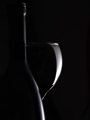 Wine Bottle and Wineglass on a Black Background