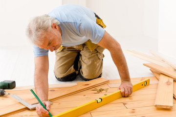 Home improvement - handyman installing wooden floor