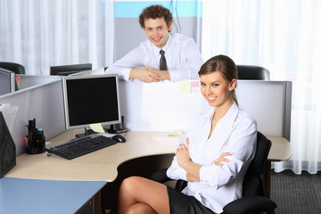 Business woman and her colleague working at office