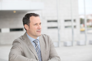 Fototapeta premium Businessman standing outside the office