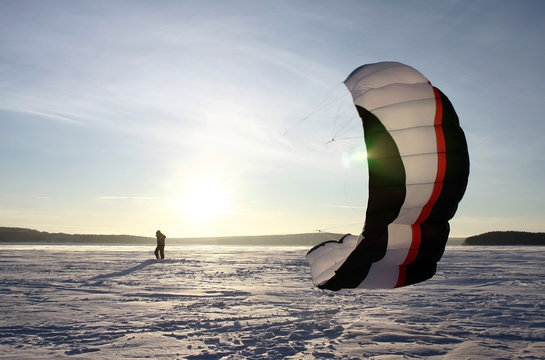 paraglider silhouette sundown blue sky background