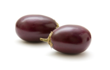 small round aubergines isolated on white background
