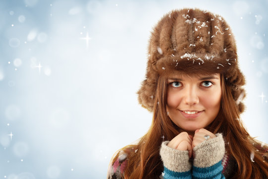 teennager girl pretty smiling on winter blue background