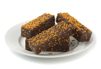 Small chocolate cake bars on plate
