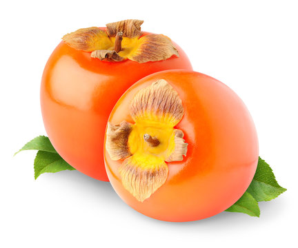 Isolated fruits. Two fresh persimmons with leaves isolated on white background
