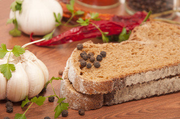 Dark bread and spices on the kitchen table