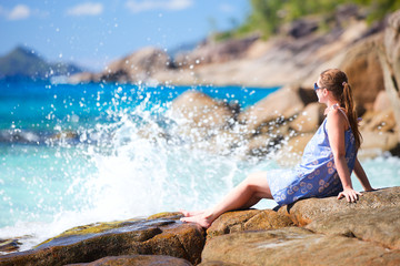 Young woman relaxing on rocky coast?
