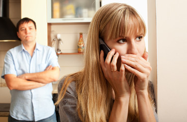 Wife confer privately on the phone