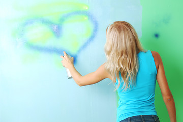 woman paints the wall
