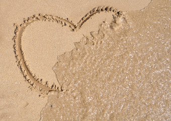Heart shape being washed away by the waves
