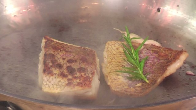 frying fish with garlic and rosemary