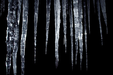 icicles insulation on a black - obrazy, fototapety, plakaty