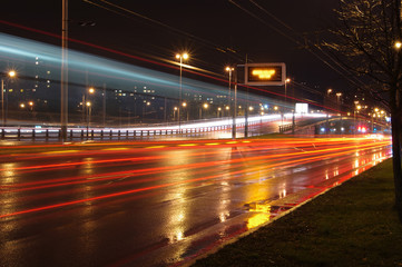 Fototapeta na wymiar Fast moving cars at night