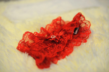red garter on fluffy yellow surface