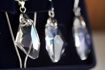 crystal earrings and a chain with pendant in a blue box