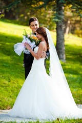 happy bride and groom at a park on their wedding day