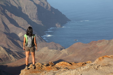 Woman hiking on top volcanic craters on St Helena